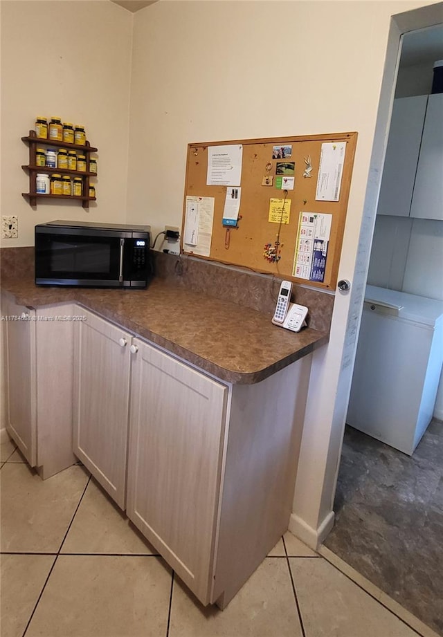 521 N 70th Way, Hollywood, FL 33024 - kitchen featuring black microwave, dark countertops, and light tile patterned floors