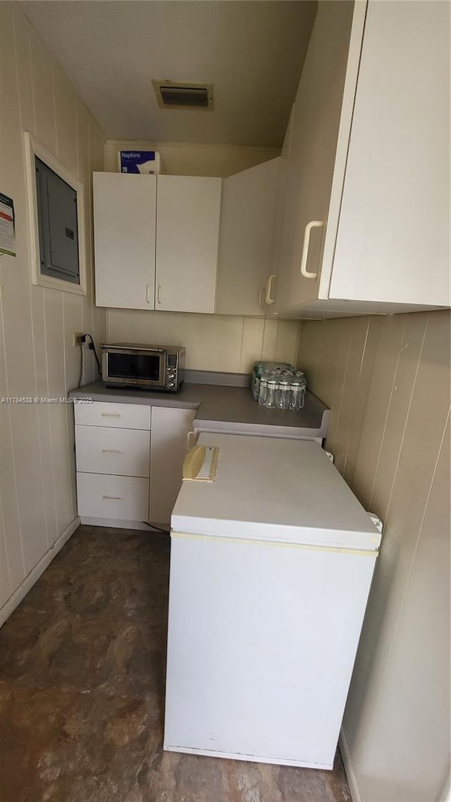 521 N 70th Way, Hollywood, FL 33024 - laundry area featuring electric panel, cabinet space, and wood walls