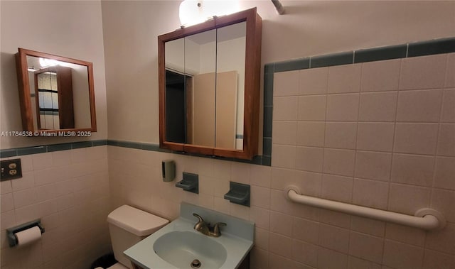 521 N 70th Way, Hollywood, FL 33024 - bathroom featuring a sink, tile walls, and toilet