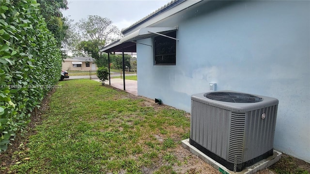 521 N 70th Way, Hollywood, FL 33024 - view of home's exterior featuring cooling unit, stucco siding, and a lawn