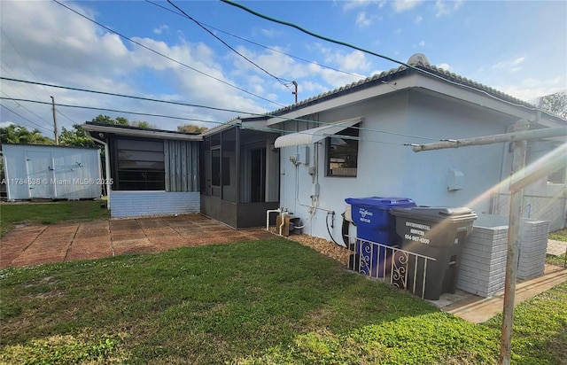 521 N 70th Way, Hollywood, FL 33024 - rear view of house with a sunroom, a yard, and stucco siding
