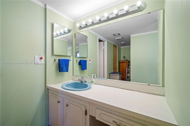 bathroom featuring crown molding, vanity, and visible vents