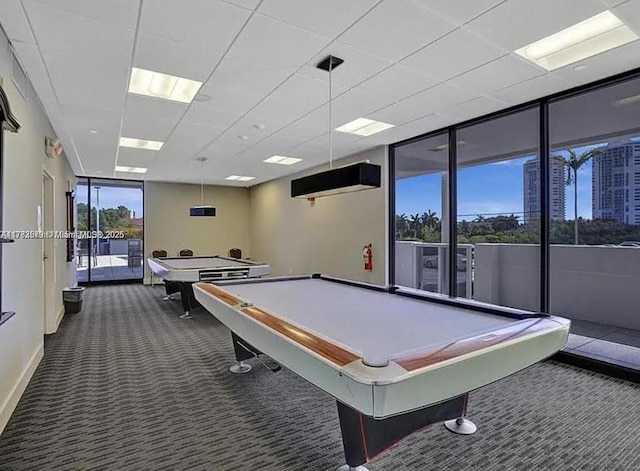 game room with a wall of windows, baseboards, dark colored carpet, and pool table