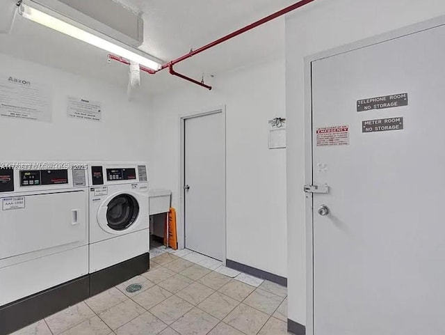 community laundry room featuring washing machine and clothes dryer