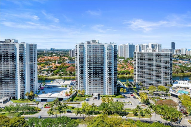 drone / aerial view featuring a city view and a water view