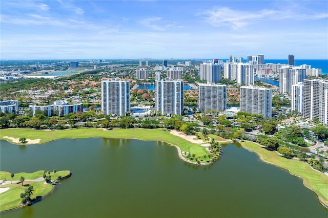 bird's eye view with view of golf course, a water view, and a view of city