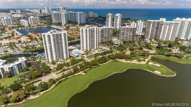 bird's eye view with golf course view, a city view, and a water view