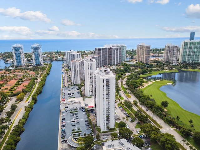 birds eye view of property with a view of city and a water view