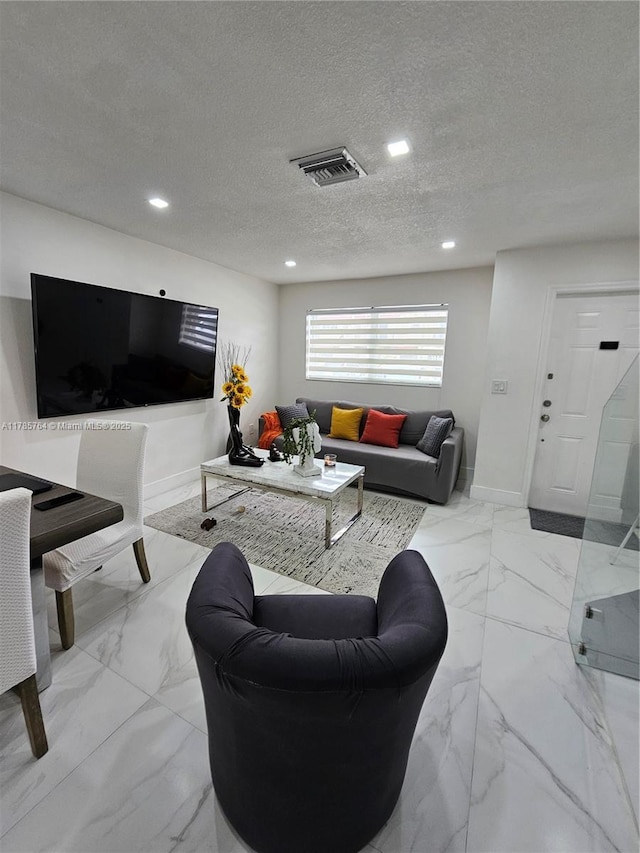 living room featuring recessed lighting, visible vents, marble finish floor, and baseboards
