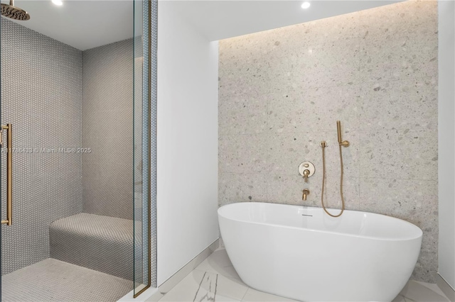 bathroom with a freestanding bath, marble finish floor, a stall shower, and recessed lighting