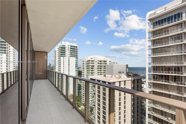 balcony featuring a view of city and a water view
