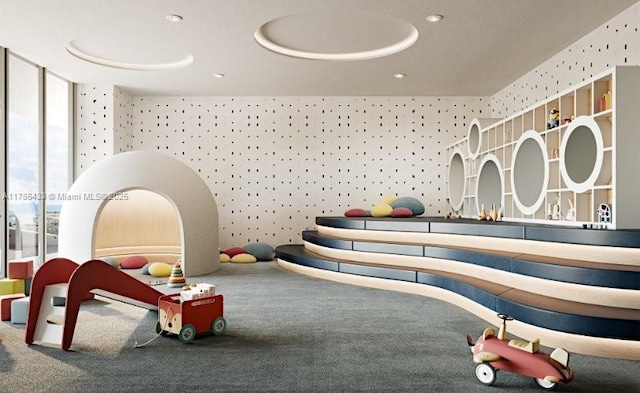 rec room featuring wallpapered walls, expansive windows, and carpet floors