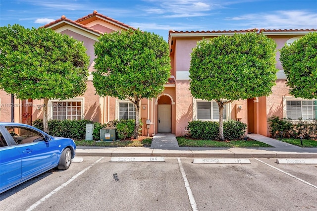 7848 Catalina Cir Unit 7848, Tamarac, FL 33321 - view of front of property with stucco siding and uncovered parking