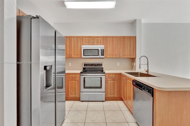 7848 Catalina Cir Unit 7848, Tamarac, FL 33321 - kitchen with appliances with stainless steel finishes, a sink, a peninsula, light tile patterned floors, and light countertops