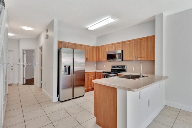 7848 Catalina Cir Unit 7848, Tamarac, FL 33321 - kitchen featuring stainless steel appliances, a sink, light tile patterned floors, a peninsula, and light countertops