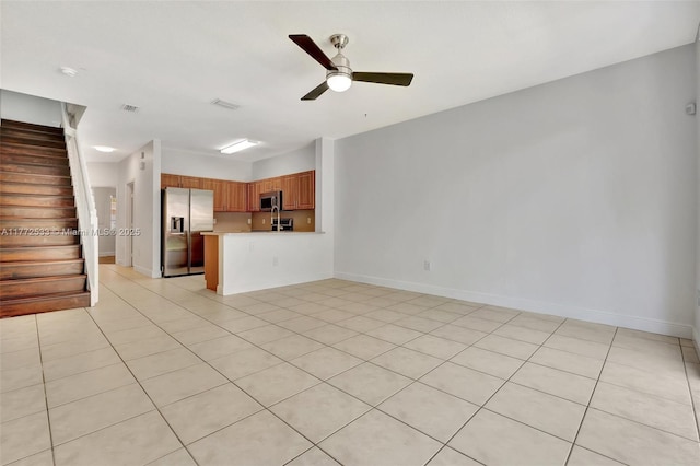 7848 Catalina Cir Unit 7848, Tamarac, FL 33321 - unfurnished living room featuring a ceiling fan, stairs, light tile patterned floors, and baseboards