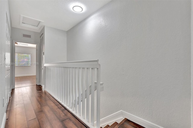 7848 Catalina Cir Unit 7848, Tamarac, FL 33321 - corridor with an upstairs landing, attic access, baseboards, wood finished floors, and a textured wall