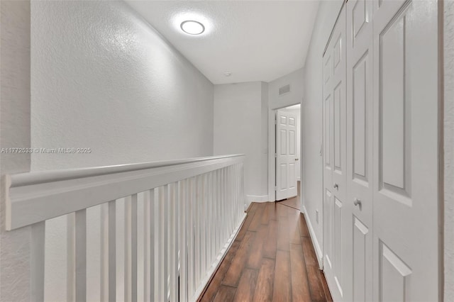7848 Catalina Cir Unit 7848, Tamarac, FL 33321 - corridor with dark wood-style floors, a textured wall, and baseboards