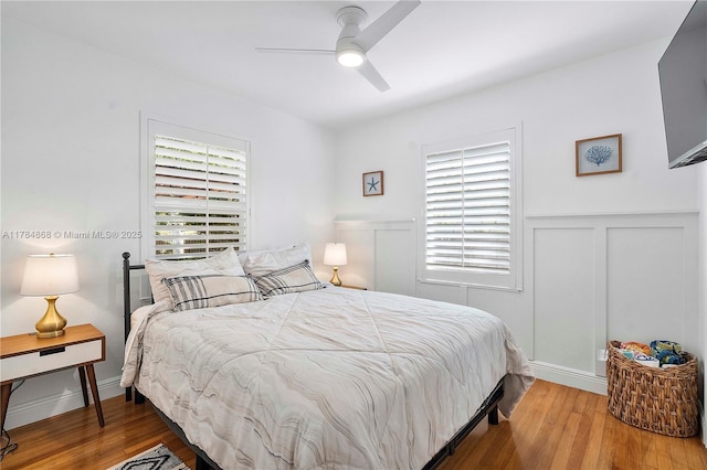 509 SW 13th St, Fort Lauderdale, FL 33315 - bedroom featuring wainscoting, a decorative wall, a ceiling fan, and wood finished floors