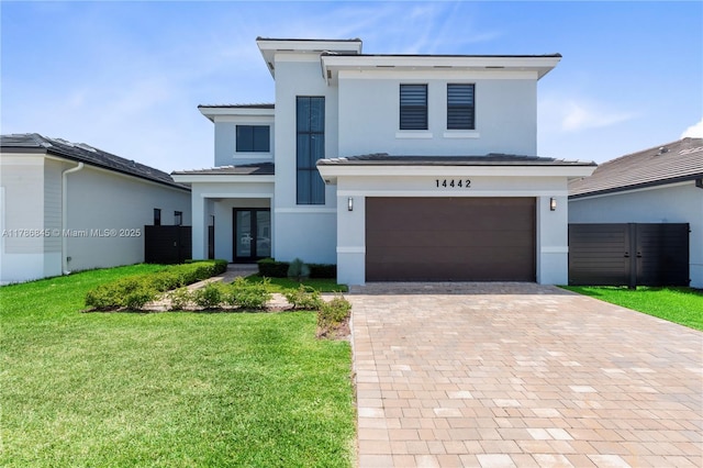 modern inspired farmhouse with stucco siding, decorative driveway, french doors, and a garage