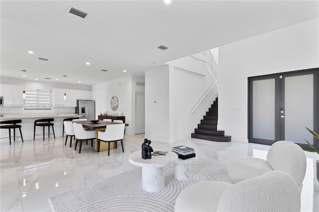 dining space with recessed lighting, marble finish floor, visible vents, and stairs