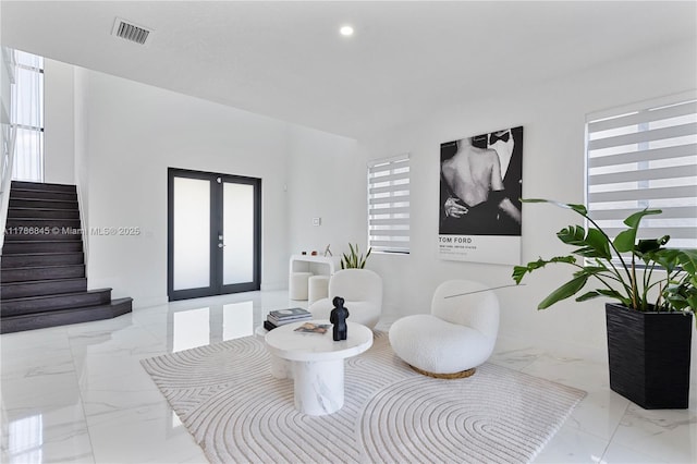 sitting room with recessed lighting, stairway, marble finish floor, visible vents, and french doors