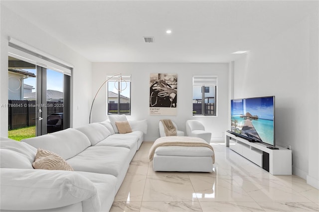 living area featuring visible vents, recessed lighting, marble finish floor, and baseboards