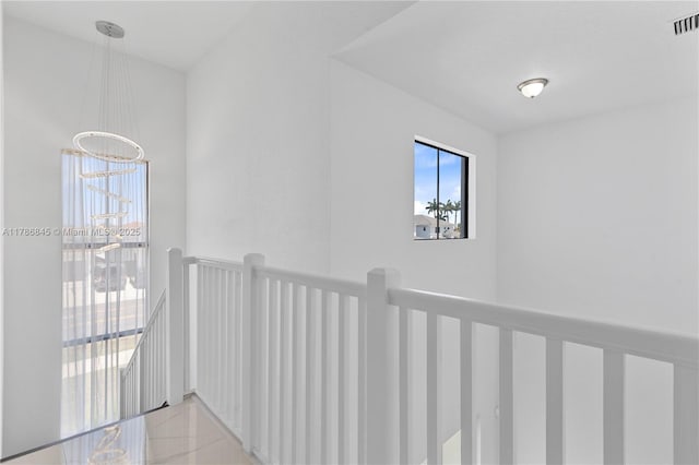 corridor with an upstairs landing and visible vents