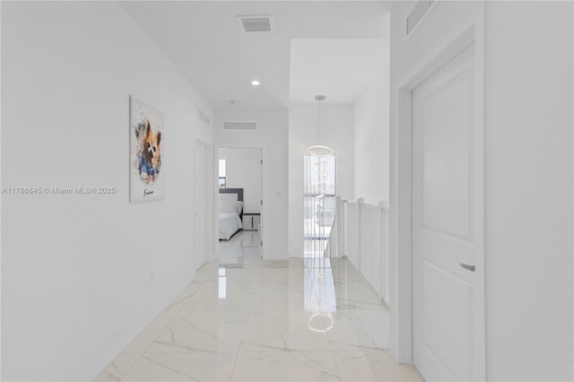 hall featuring recessed lighting, marble finish floor, and visible vents