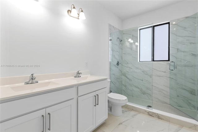 bathroom featuring toilet, a marble finish shower, a sink, and marble finish floor