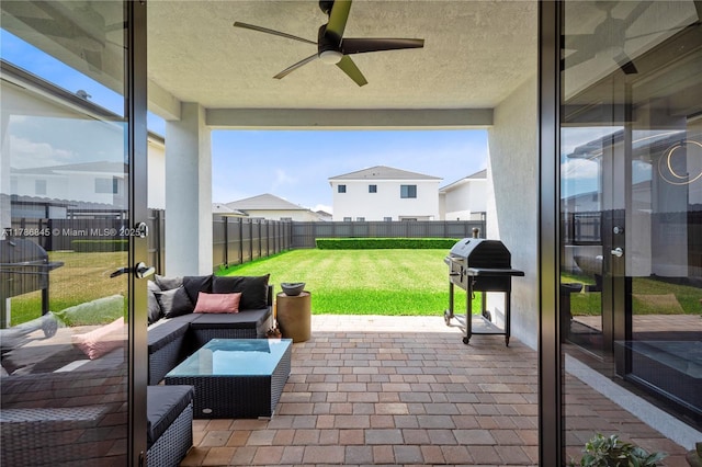 view of patio / terrace featuring an outdoor living space, ceiling fan, a grill, and a fenced backyard
