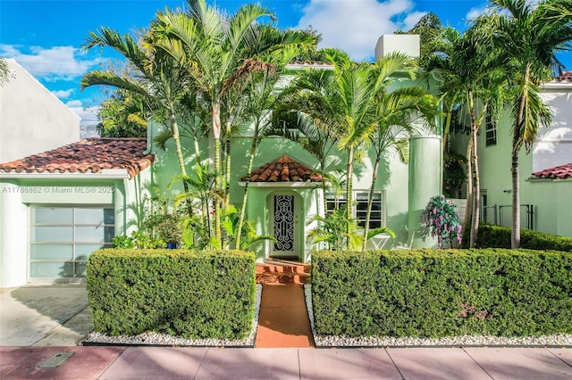 837 Espanola Way, Miami Beach, FL 33139 - view of front facade featuring stucco siding, a tiled roof, and a garage