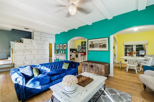 837 Espanola Way, Miami Beach, FL 33139 - living area featuring arched walkways, visible vents, light wood-style floors, beamed ceiling, and ceiling fan