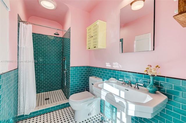 837 Espanola Way, Miami Beach, FL 33139 - bathroom with tile walls, tile patterned flooring, toilet, and wainscoting