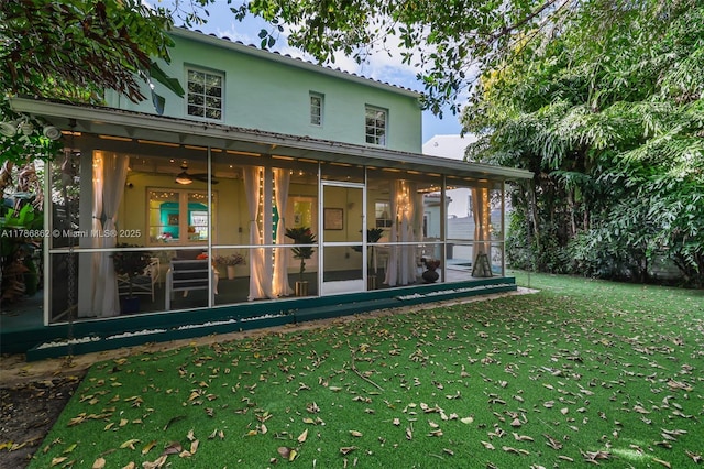 837 Espanola Way, Miami Beach, FL 33139 - back of house with stucco siding, a sunroom, a yard, and ceiling fan