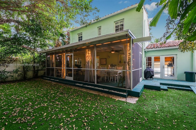837 Espanola Way, Miami Beach, FL 33139 - back of house with french doors, fence, a lawn, a sunroom, and stucco siding
