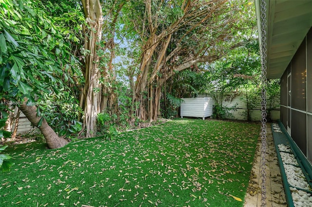 837 Espanola Way, Miami Beach, FL 33139 - view of yard with fence, an outbuilding, a sunroom, and a storage shed
