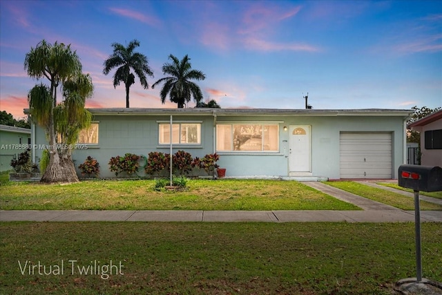 ranch-style home with a lawn, stucco siding, and a garage