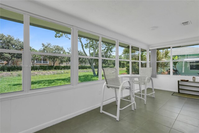 632 Hummingbird Ln, Delray Beach, FL 33445 - sunroom / solarium featuring plenty of natural light, tile patterned flooring, and baseboards