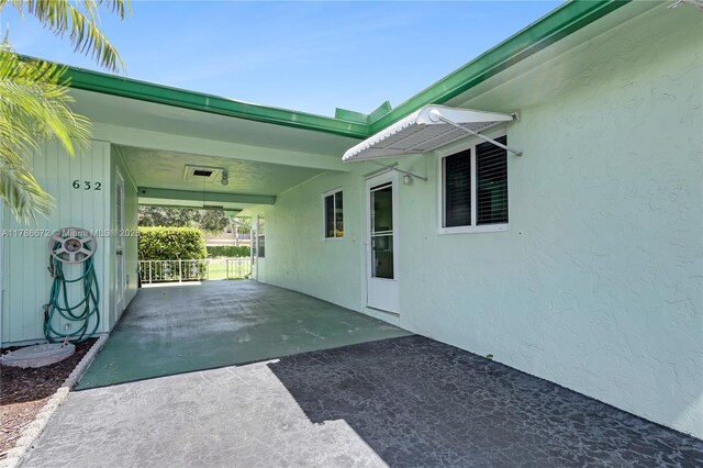632 Hummingbird Ln, Delray Beach, FL 33445 - view of patio / terrace featuring driveway and a carport