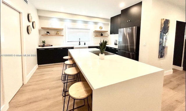 2360 SW 12th St, Miami, FL 33135 - kitchen featuring dark cabinetry, open shelves, a sink, and freestanding refrigerator