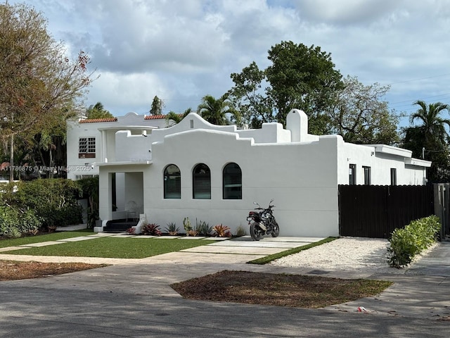 2360 SW 12th St, Miami, FL 33135 - mediterranean / spanish-style house with a front lawn, fence, and stucco siding