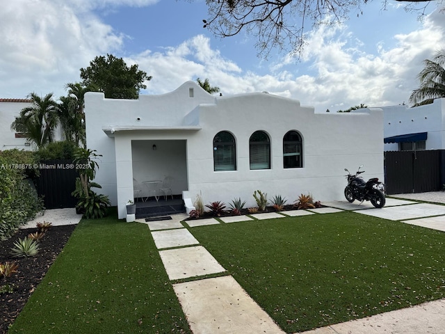 2360 SW 12th St, Miami, FL 33135 - mediterranean / spanish-style house with fence, a front lawn, and stucco siding