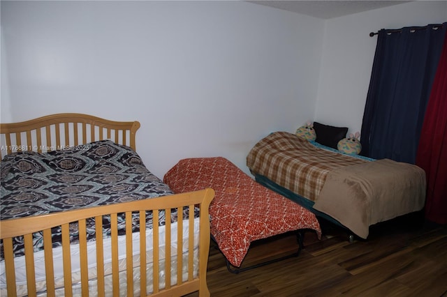 bedroom with wood finished floors