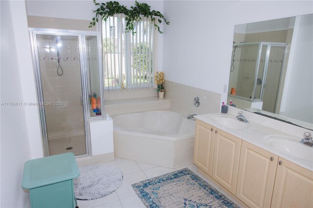 full bathroom featuring a bath, tile patterned floors, a stall shower, and a sink