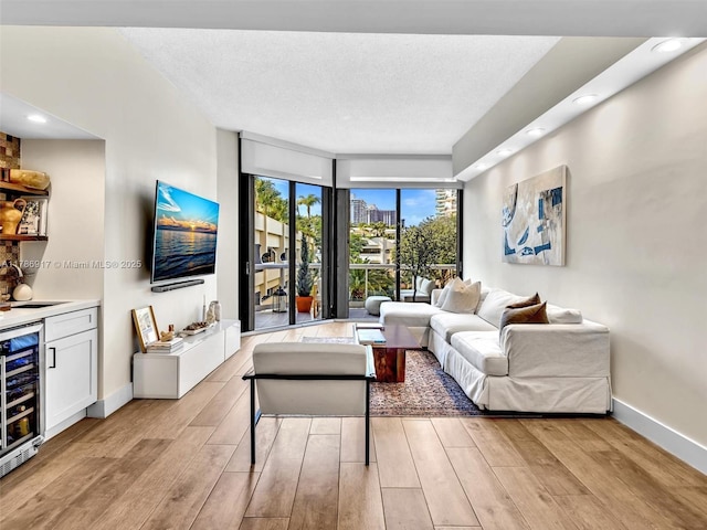 20191 E Country Club Dr Unit 311, Aventura, FL 33180 - living area featuring wine cooler, baseboards, recessed lighting, and light wood-style floors