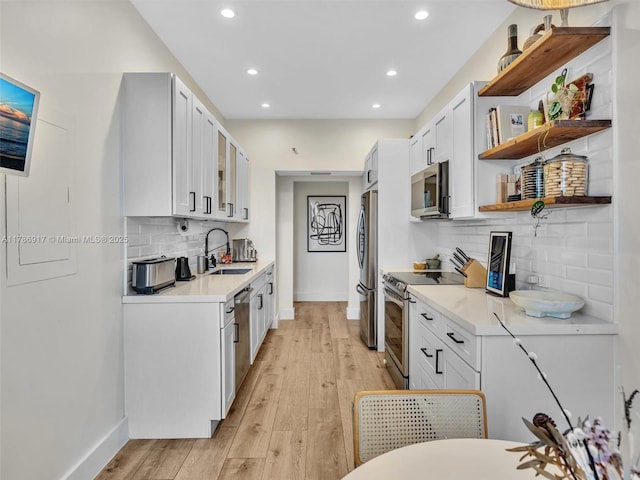 20191 E Country Club Dr Unit 311, Aventura, FL 33180 - kitchen with a sink, baseboards, recessed lighting, open shelves, and appliances with stainless steel finishes