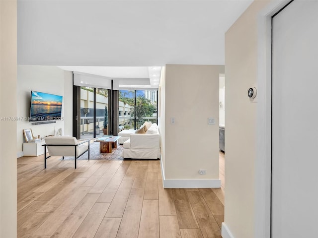 20191 E Country Club Dr Unit 311, Aventura, FL 33180 - living area featuring expansive windows, light wood-style flooring, and baseboards
