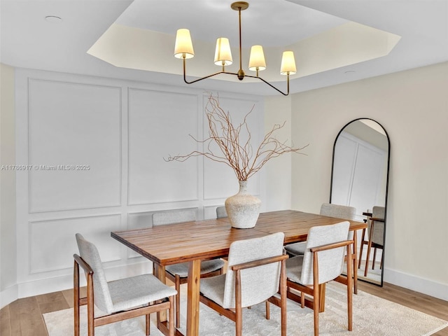 20191 E Country Club Dr Unit 311, Aventura, FL 33180 - dining area featuring a chandelier, a decorative wall, light wood finished floors, and baseboards