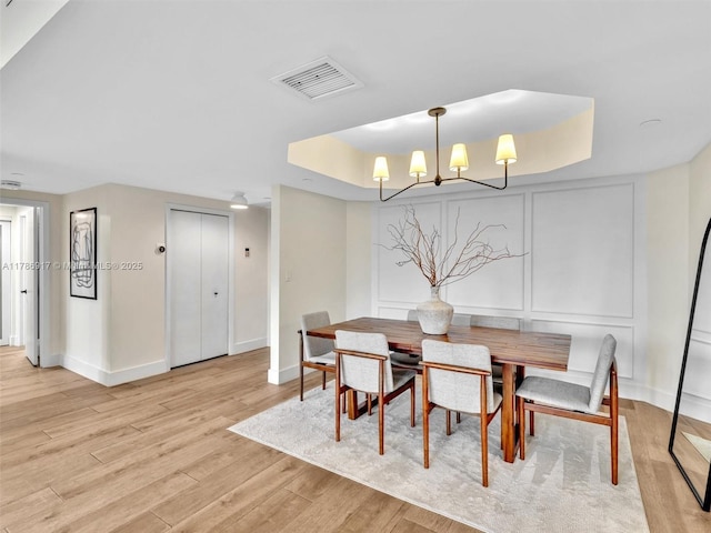 20191 E Country Club Dr Unit 311, Aventura, FL 33180 - dining room with an inviting chandelier, light wood finished floors, a raised ceiling, baseboards, and visible vents